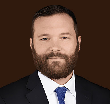 Headshot of Travis Granger, bearded man in suit. Rated 5 stars.
